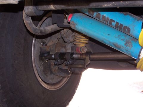 1986 Ford Bronco - Detail of the front suspension system, blue Rancho shocks and visible steering components.