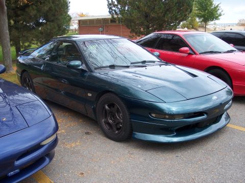 1996 Ford Probe - Three Ford Probes are parked in a lot, with a dark green one in the foreground.