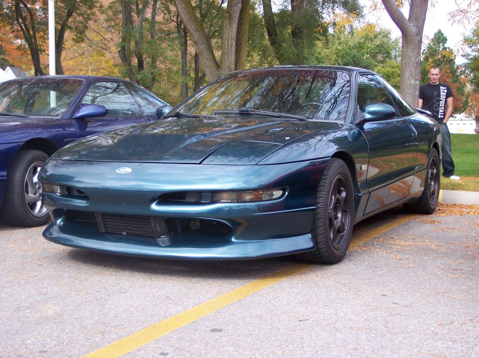 Dark teal 1996 Ford Probe parked on asphalt.
