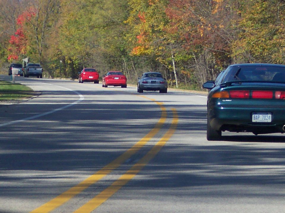 1996 Ford Probe rear view, dark green, license plate BAP 7024, autumn foliage