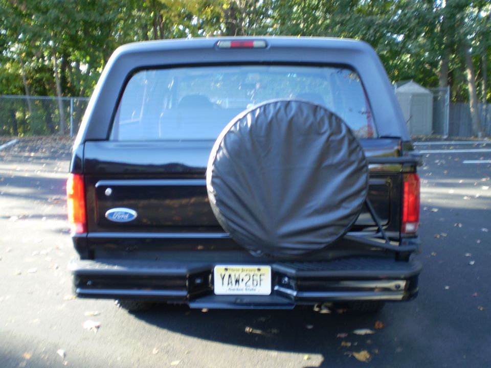 Rear view of a black 1996 Ford Bronco with a spare tire on the back and a NJ license plate.