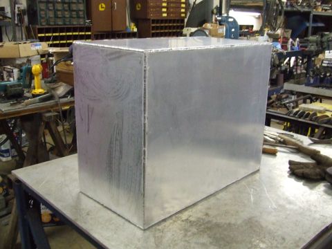 1967 Ford Bronco - Clear plastic box sits on a table in a workshop environment.