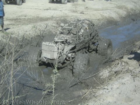 1990 Ford Bronco - Photo of a tube-frame rock buggy stuck in mud, not a technical document.
