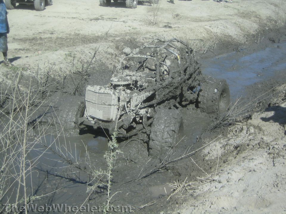 Stripped tube-chassis rock buggy stuck in a muddy trench