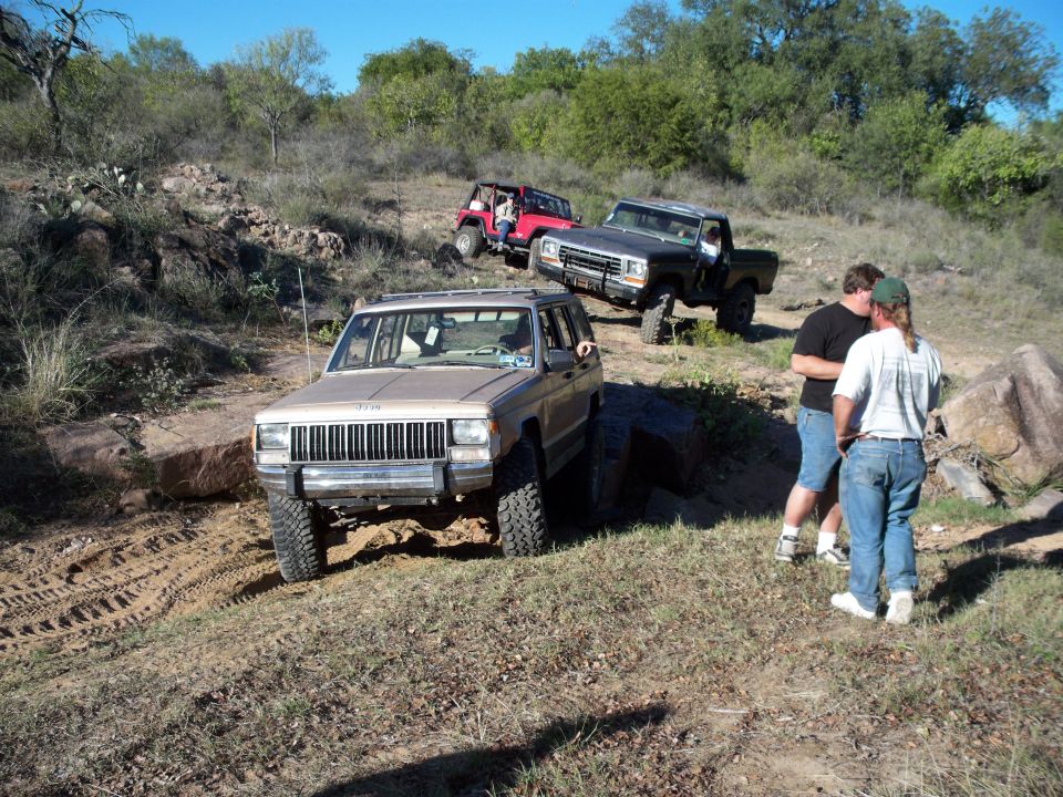 Three off-road vehicles on a dirt trail.