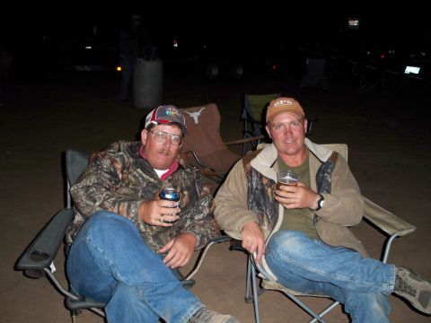 1996 Ford Bronco - Two men relax in camping chairs at night, holding beverages and enjoying the outdoors.