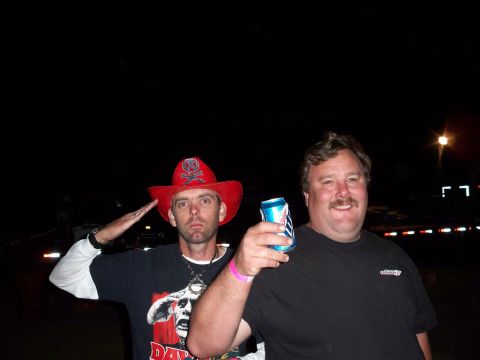 1996 Ford Bronco - Two men pose for a photo at night, one wearing a red cowboy hat and the other holding a beverage.