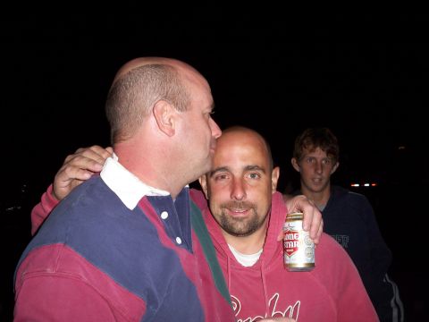 1996 Ford Bronco - Three men are together outdoors at night, with one holding a beer can and another giving him a kiss on the forehead.