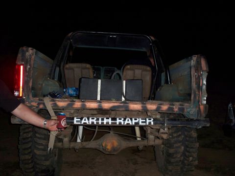 1996 Ford Bronco - Modified SUV with custom paint and text on the rear bumper.