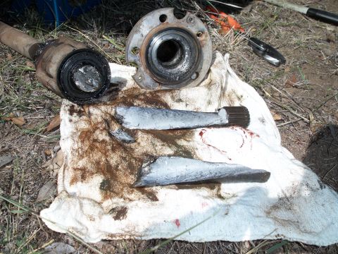 1996 Ford Bronco - Damaged vehicle parts lie on a cloth, indicating a mechanical failure.