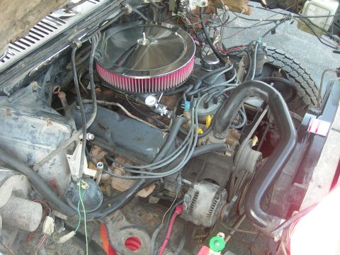 1985 Ford Bronco - Close-up view of a vehicle's engine bay, showing various components and wiring.