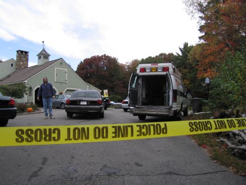 2001 Ford Crown Victoria - Yellow police tape blocks access to a scene with multiple vehicles, including an ambulance and two sedans.
