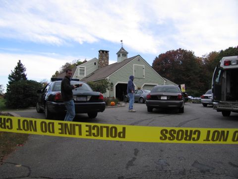 2001 Ford Crown Victoria - A 2001 Ford Crown Victoria police car is visible behind police tape at a scene with multiple vehicles and people.