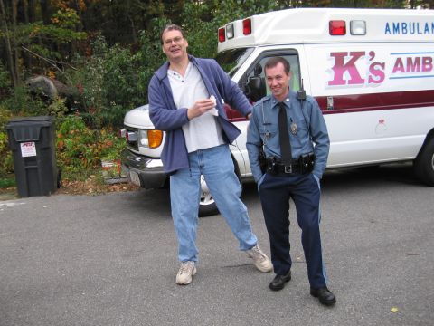 2001 Ford Crown Victoria - An ambulance with 'K's AMBULANCE' written on the side is parked on a street with two men standing nearby.