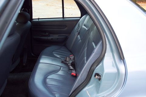 2001 Ford Crown Victoria - Rear interior view of a 2001 Ford Crown Victoria, showing the seats and door panel.