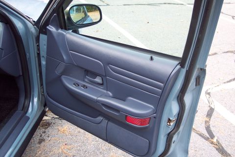 2001 Ford Crown Victoria - Interior view of a 2001 Ford Crown Victoria's driver's side door panel, showing the armrest and controls.