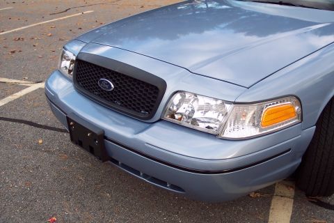 2001 Ford Crown Victoria - Front view of a blue 2001 Ford Crown Victoria, showing its distinctive grille and headlights.