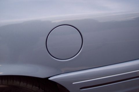 2001 Ford Crown Victoria - Fuel filler door on the side of a car.