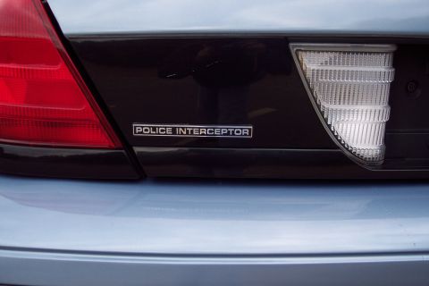 2001 Ford Crown Victoria - Close-up of the rear of a police vehicle, showing the 'Police Interceptor' badging.