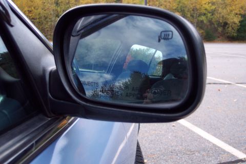 2001 Ford Crown Victoria - Reflection in the side mirror shows the interior and trees outside.