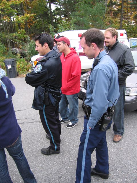 2001 Ford Crown Victoria - Police officers and an ambulance are gathered near parked vehicles.