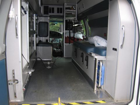 2001 Ford Crown Victoria - Interior view of an ambulance, equipped with a patient bench and storage compartments.