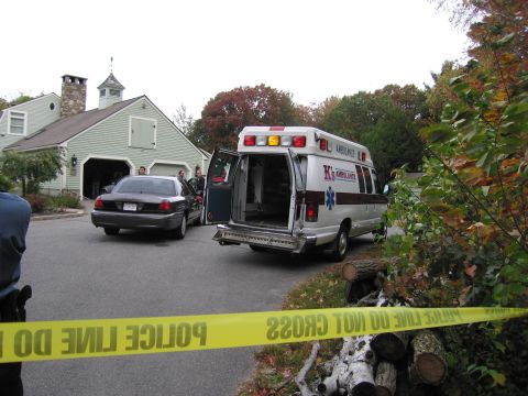 2001 Ford Crown Victoria - A police car and an ambulance are present at a scene, cordoned off by police tape.