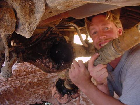 1985 Ford Bronco - A man poses with a driveshaft, suggesting a repair or modification to a vehicle's rear end.