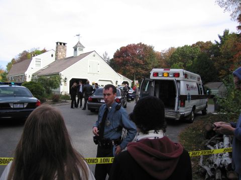 2001 Ford Crown Victoria - Emergency vehicles and law enforcement are present at a scene cordoned off with police tape.