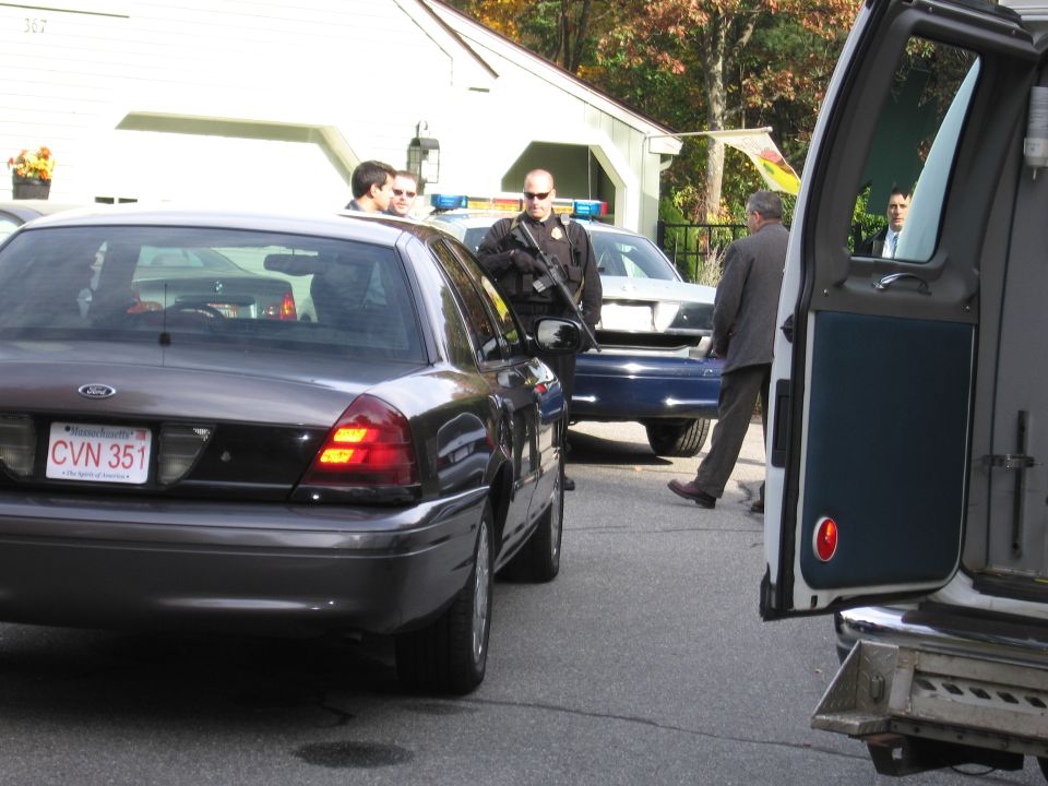 2001 Ford Crown Victoria police car parked next to another police car, officers present