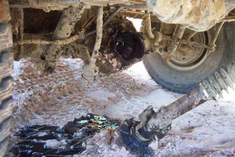 1985 Ford Bronco - The rear differential and driveshaft of a 1985 Ford Bronco appear to be severely damaged.