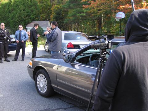 2001 Ford Crown Victoria - A film crew documents a scene involving police officers and a Ford Crown Victoria.