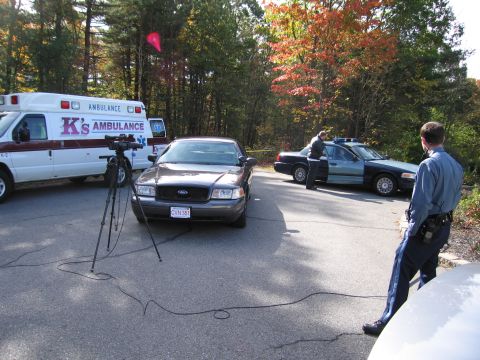 2001 Ford Crown Victoria - Emergency vehicles, including an ambulance and two police cars, are gathered at a scene.