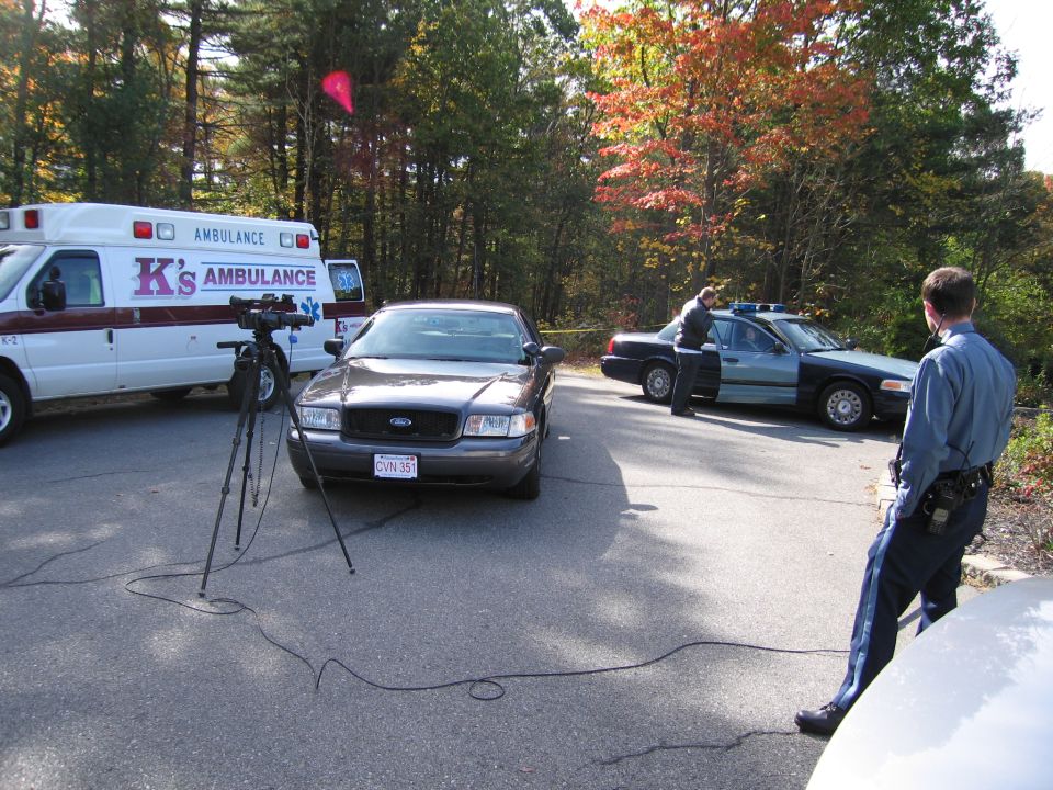 2001 Ford Crown Victoria police car parked next to an ambulance and another police car