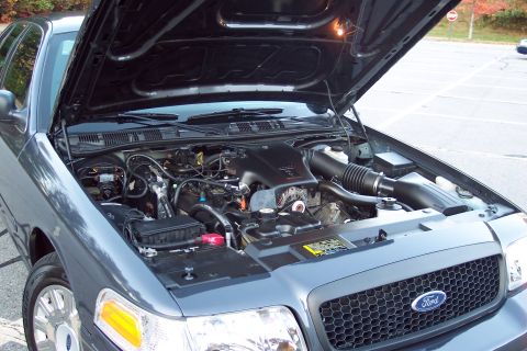 2001 Ford Crown Victoria - Engine bay of a 2001 Ford Crown Victoria, viewed from the front with the hood raised.