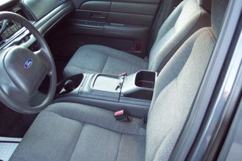 2001 Ford Crown Victoria - Interior view of a 2001 Ford Crown Victoria, showing the front seats, steering wheel, and center console.