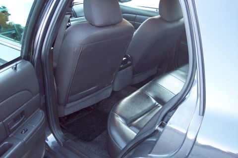 2001 Ford Crown Victoria - Rear interior view of a 2001 Ford Crown Victoria, showing the back seats and door panel.