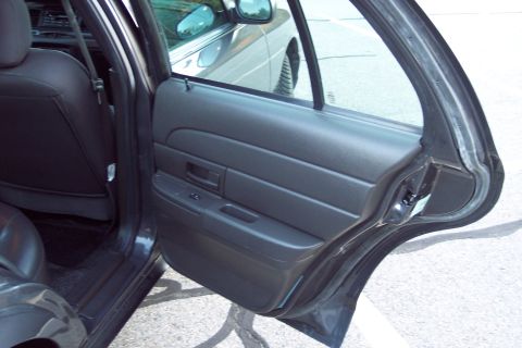 2001 Ford Crown Victoria - Interior view of a 2001 Ford Crown Victoria, showing the door panel and rear seat.