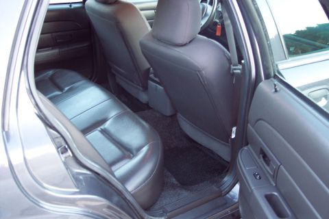 2001 Ford Crown Victoria - Interior view of the back seats and door panel of a Ford Crown Victoria.