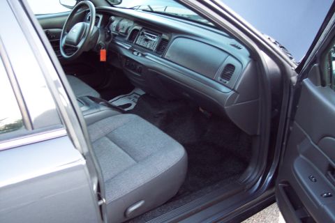 2001 Ford Crown Victoria - Interior view of a 2001 Ford Crown Victoria, highlighting the dashboard and seating.