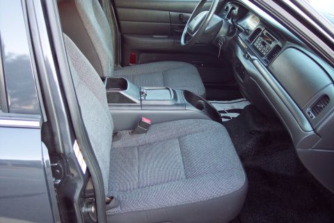 2001 Ford Crown Victoria - The interior of a police car, cloth seats and a standard dashboard layout.