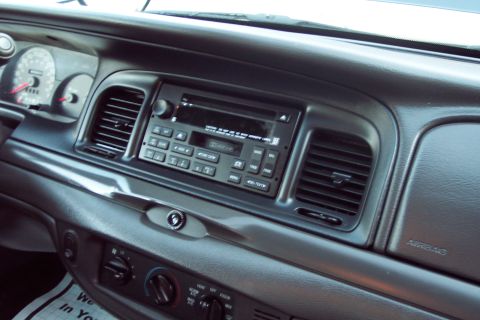 2001 Ford Crown Victoria - The interior dashboard of a 2001 Ford Crown Victoria features a standard radio and climate controls.