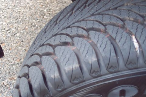 2001 Ford Crown Victoria - A detailed view of a tire's tread pattern, showing its condition and texture.