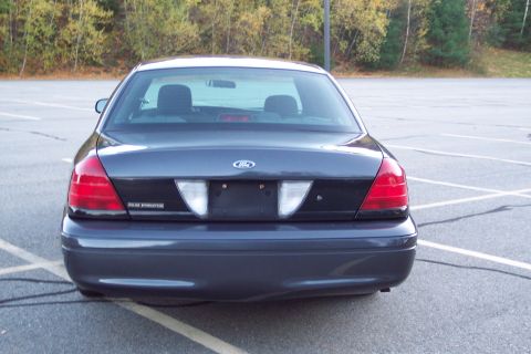 2001 Ford Crown Victoria - Rear view of a dark 2001 Ford Crown Victoria with 'Police Interceptor' badging.