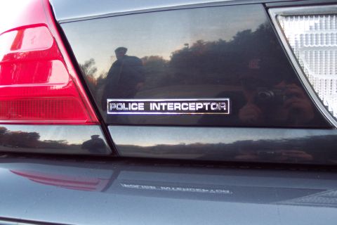 2001 Ford Crown Victoria - The "POLICE INTERCEPTOR" badge is clearly visible on the trunk of the vehicle.