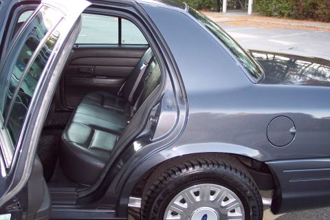 2001 Ford Crown Victoria - Rear interior view of a 2001 Ford Crown Victoria with the back door open.