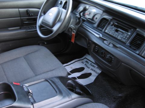 2001 Ford Crown Victoria - The interior of the vehicle shows the dashboard, steering wheel, and center console area.