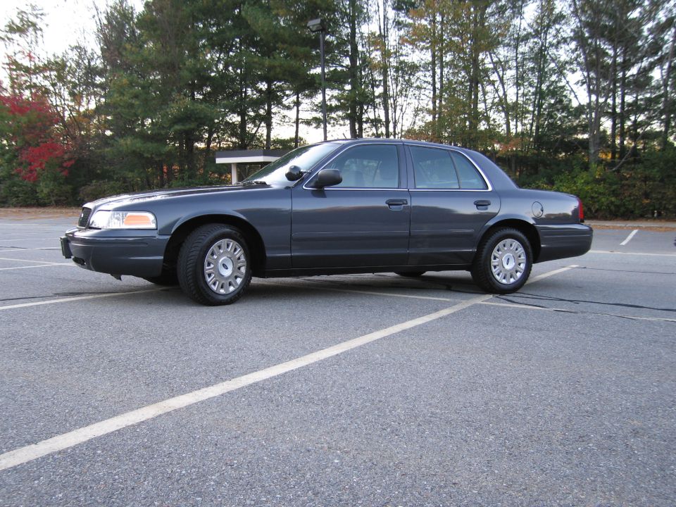 Ford Crown Victoria sedan, driver-side profile view in parking lot