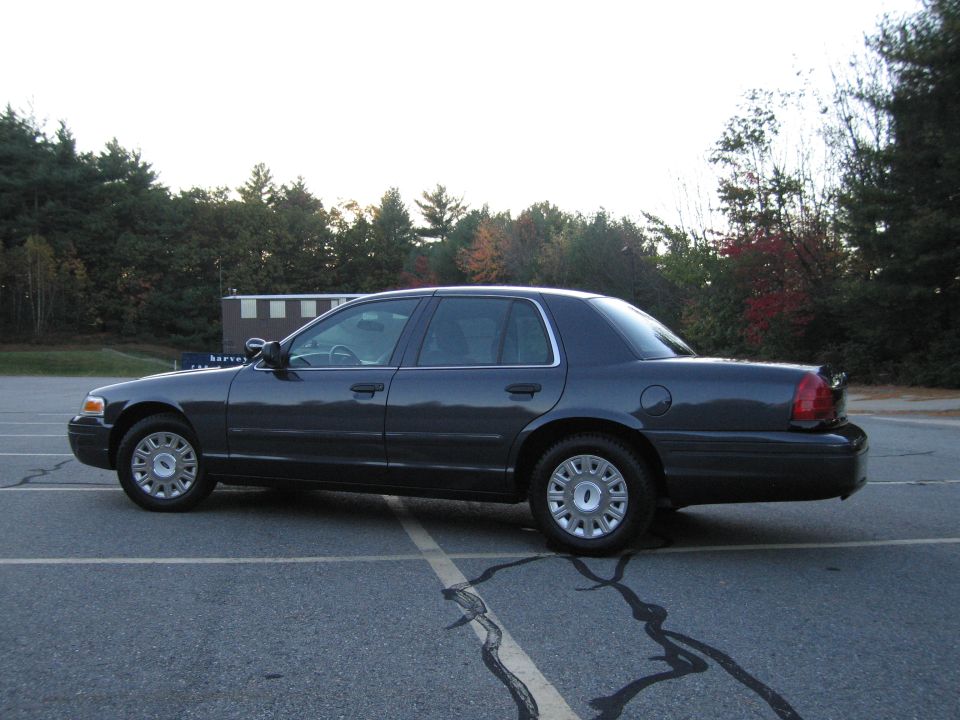 Ford Crown Victoria sedan, rear three-quarter view in parking lot
