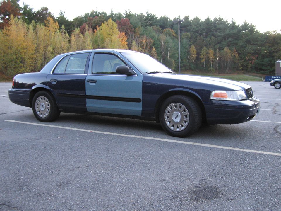 Two-tone blue Ford Crown Victoria side profile view